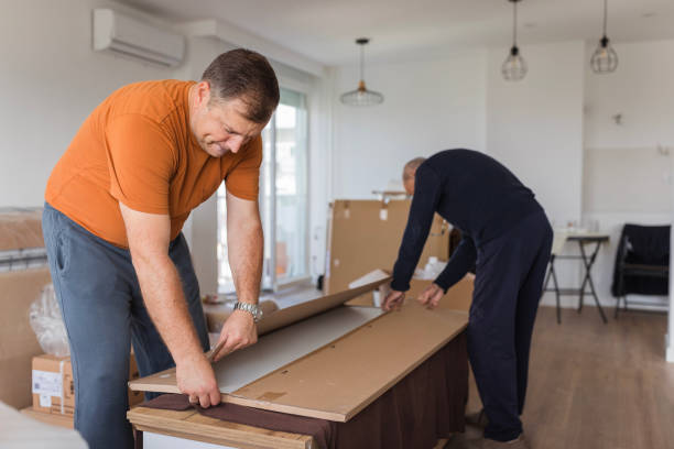 istock Men taking a big cardboard box onto a table 1435099529