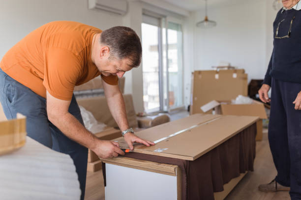 istock Men taking a big cardboard box onto a table 1435100090