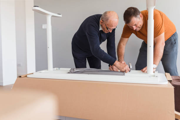 istock Elderly man helping his son using work tools to finish assembling new furniture 1435100382