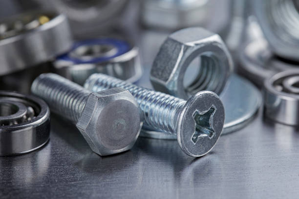 istock set of different nuts, bolts, screws, washers and drill bits,thread tap and mill cutters on steel plate background. Locksmithing deal. 1435100674