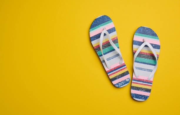 istock Summer slippers slates on a yellow background, top view 1435104172
