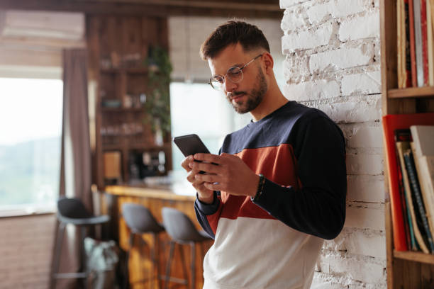 istock Caucasian man texting at home. 1435104398