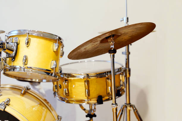 istock drum set in yellow on white background 1435113338