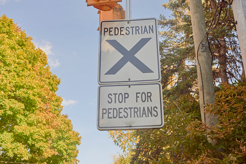 A stop for pedestrian sign with an x on it.