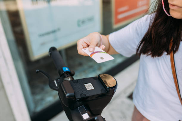 istock Woman using credit card for renting electric scooter 1435119515