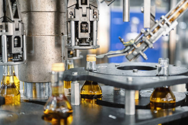 istock Automatic equipment puts caps on alcohol beverage bottles 1435119534
