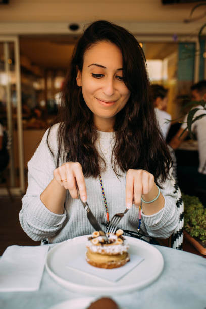 istock Eating delicious french dessert hazelnut paris brest 1435119748