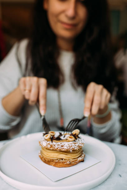 istock Eating delicious french dessert hazelnut paris brest 1435119784