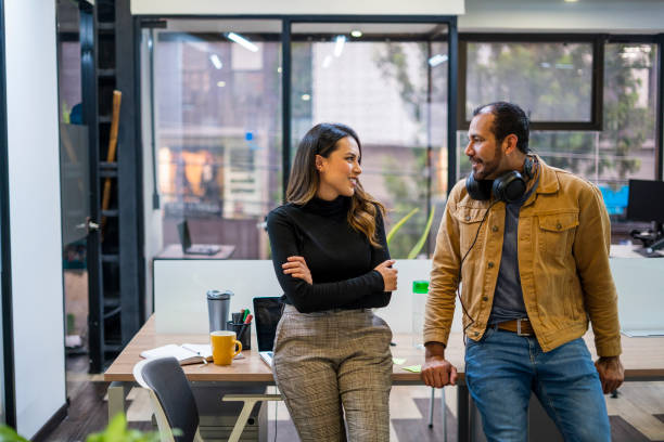 istock Coworkers are talking about work in the office 1435120551