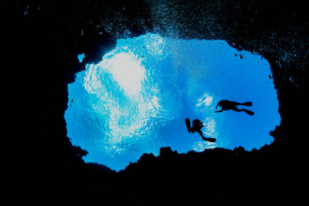 SCUBA Divers at an Entrance to Famous Turtle Cove, Palau, Micronesia stock photo
