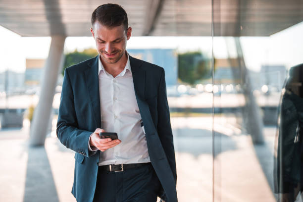 istock Handsome Caucasian Businessman Using A Smart Phone Outdoors In The City 1435123926