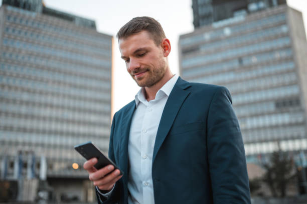 istock Handsome Caucasian Businessman Using A Smart Phone Outdoors In The City 1435124024
