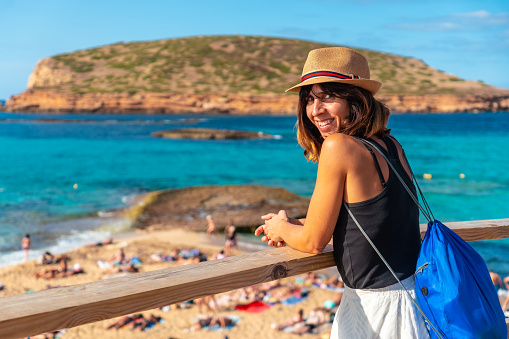 A tourist enjoying the peace at Cala Comte beach on the island of Ibiza. Sunset. Balearic