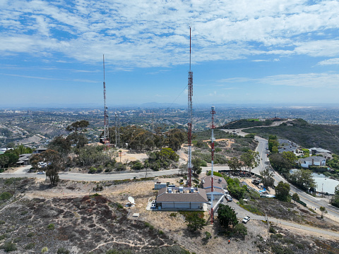 Aerial view of telecommunication tower with 5G cellular network antenna on the top of a valley in San Diego, South California