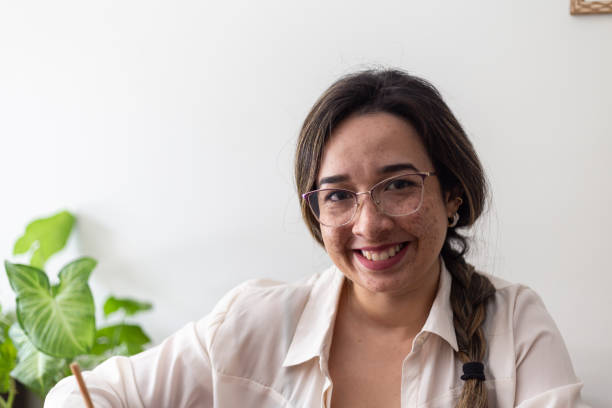 istock Latin woman using laptop at home 1435126623