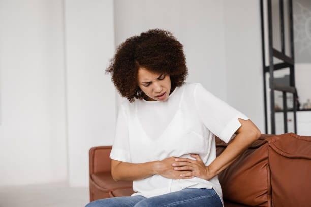 Stomach pain. Pancreatitis disease of pancreas becomes inflamed. Sick african american girl hold abdomen because it hurts. Stomach pain. Pancreatitis disease of pancreas becomes inflamed. Sick african american girl hold abdomen because it hurts endometriosis bloated stock pictures, royalty-free photos & images