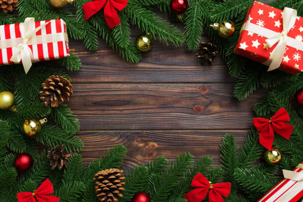 istock Christmas decorations and fir tree branch and gift boxon dark table. Top view frame with copy space 1435138220