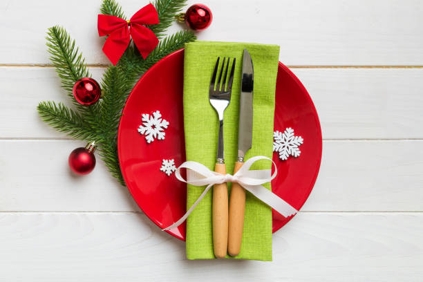istock Christmas table place setting with christmas decor and plates, kine, fork and spoon. Christmas holiday background. Top view with copy space 1435138225