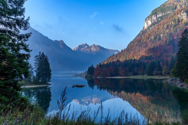 istock Scenic waterscape surrounded by mountains and vegetation 1435139871