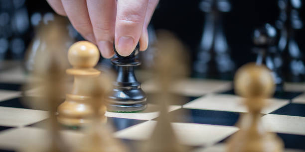 istock Chess player moving with pawn piece 1435151179