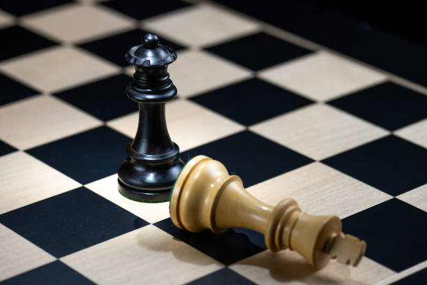 istock Pair of black and white chess pieces on chequered chessboard 1435151212