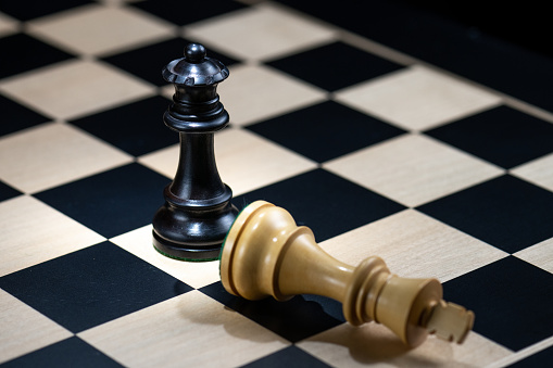 Business people are thinking about chessboard chess gold and silver are on the table.