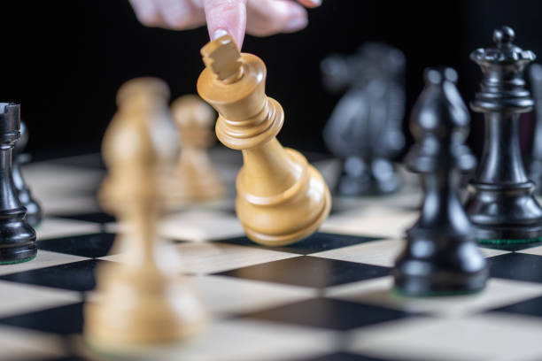 istock End of game, laying down king piece 1435151219