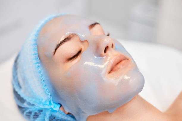 istock beautiful woman with blue alginate mask on face 1435151848
