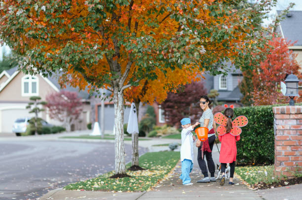 istock Young Family Trick Or Treating Together 1435158874