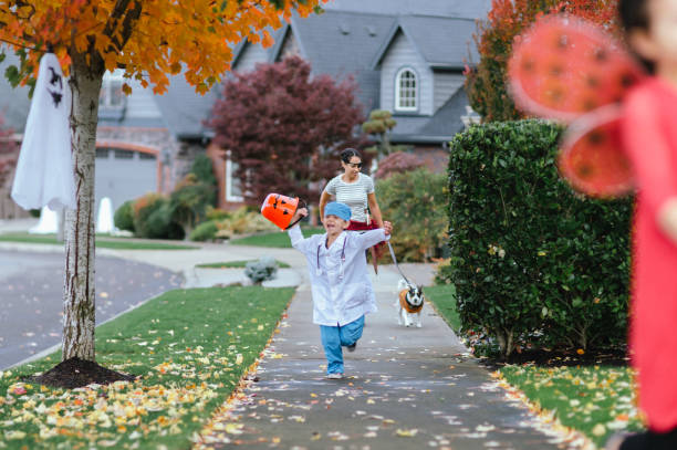 istock Young Family Trick Or Treating Together 1435158876