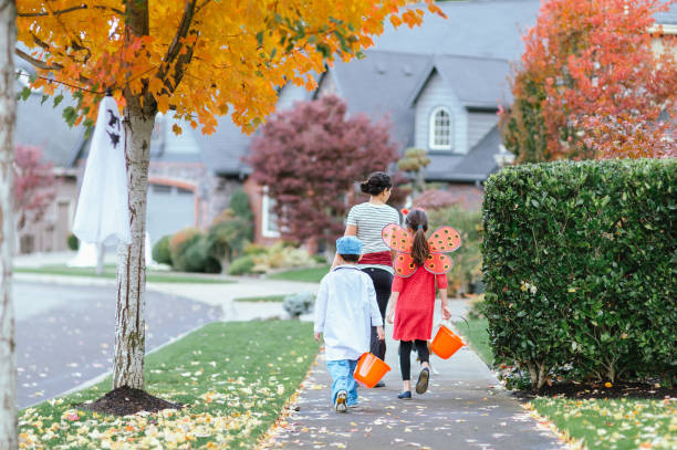 istock Young Family Trick Or Treating Together 1435158878