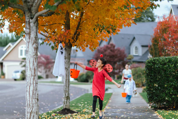 istock Young Family Trick Or Treating Together 1435158880
