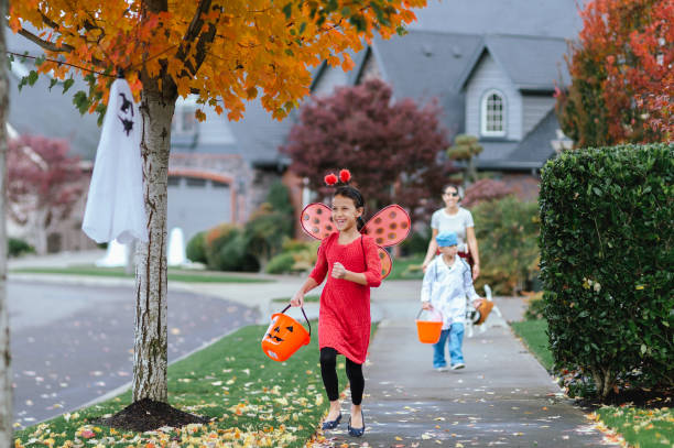 istock Young Family Trick Or Treating Together 1435158884