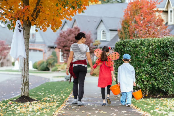 istock Young Family Trick Or Treating Together 1435158885