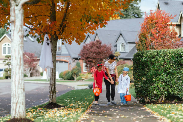 istock Young Family Trick Or Treating Together 1435158886