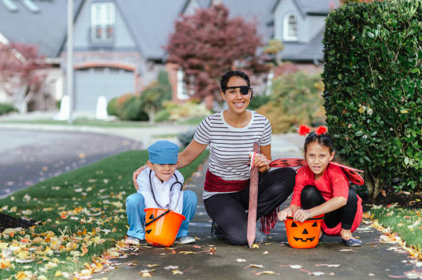 istock Young Family Trick Or Treating Together And Posing For Camera 1435158896