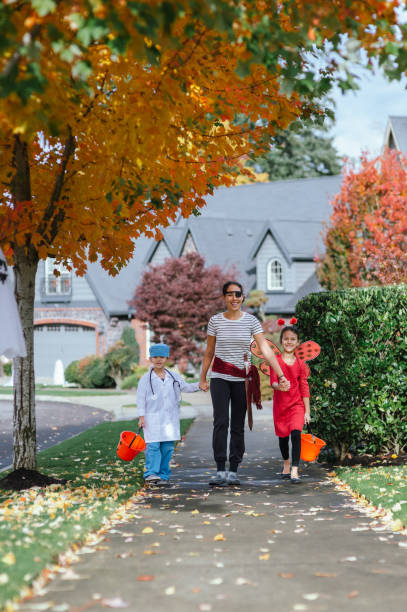 istock Young Family Trick Or Treating Together 1435158897