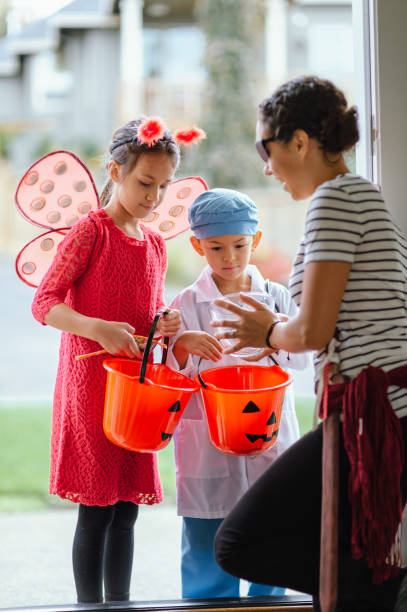 istock Adorable children trick or treating 1435158909
