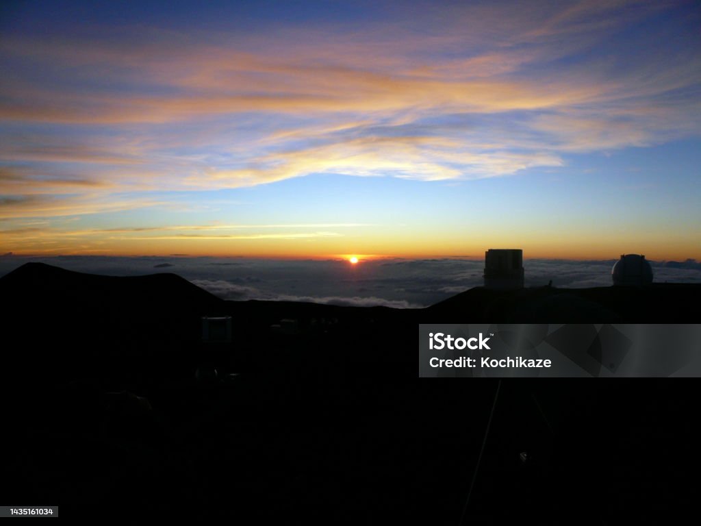 Two Astronomical Telescopes at the Summit of Maunakea in the Twilight This shot is the scene around the summit of Mauna kea in Hawaii Island. We can see a much beautiful sunset behind the grand views of astronomical telescopes. Astronomy Stock Photo