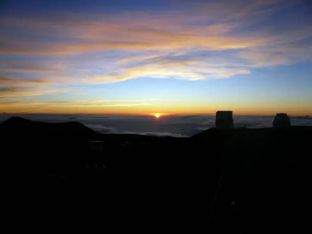 This shot is the scene around the summit of Mauna kea in Hawaii Island. We can see a much beautiful sunset behind the grand views of astronomical telescopes.