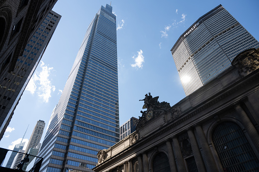 Low angle view of skyscrapers against blue sky with copy space.