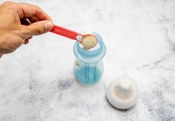 istock Infant formula being placed with a dispenser in a bottle. It is recommended for infants who cannot be breastfed to meet the nutritional needs of infants and young children. 1435161981