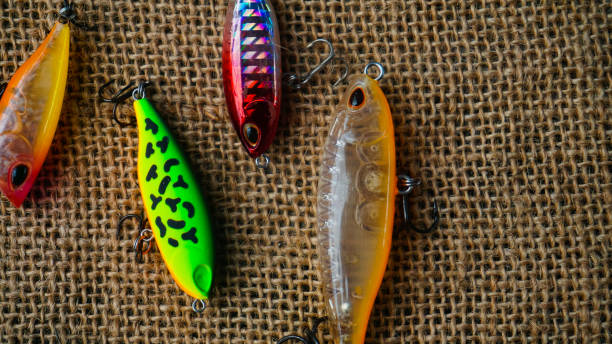 istock Artificial lure made from plastic for fishing by casting. Casting lure with hook with blur background, Artificial lure with the shape of minnow - Selected Focus 1435162512