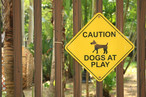 Caution – Dogs at Play Sign Outside a Pet Park