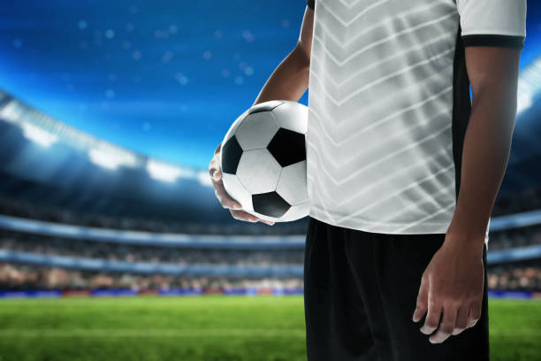 istock Soccer player holding ball in the stadium 1435167373