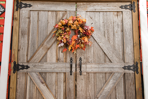 Wooden Country Farm Double Doors With a Autumn Wreath on Them at a Pumpkin Patch