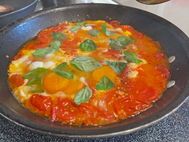 istock Eggs Cooking in Tomato Sauce with Basil 1435185320