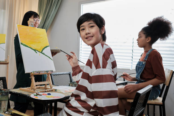 istock Asian boy with acrylic painting in an art classroom at elementary art studio. 1435191278