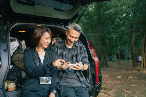 istock Asian senior couple preparing gear for hike. 1435198909