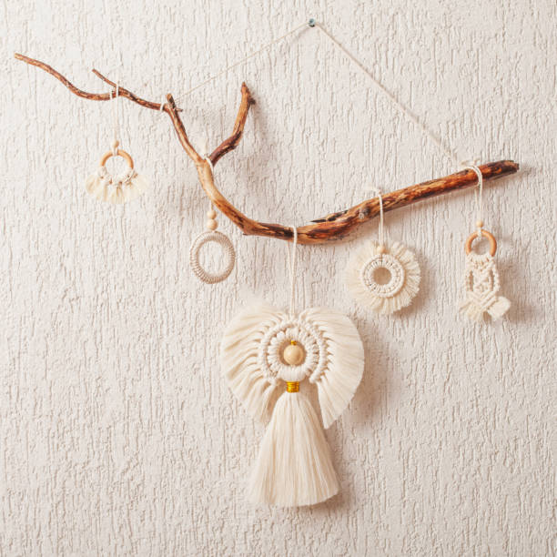 istock Christmas macrame decor. Christmas angel and decorative elements on wooden stick. Natural materials - cotton thread, wood beads. Eco decorations, ornaments, hand made decor. Copy space 1435217037